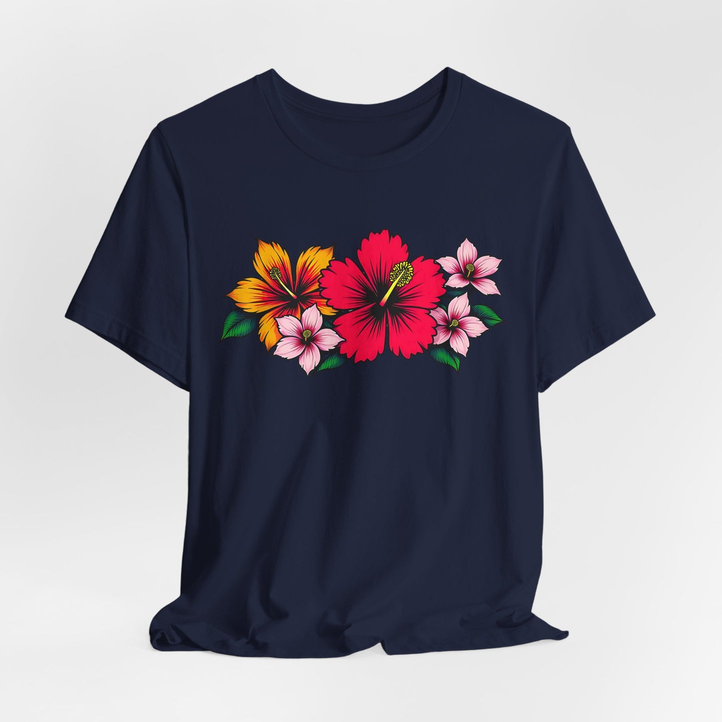 Ideal for summer and beach days, the Tropical Floral Unisex Jersey T-Shirt features vibrant floral designs—including a bold red hibiscus, yellow-orange flower, and delicate pink blooms—across the navy blue chest. Perfect for casual gatherings.