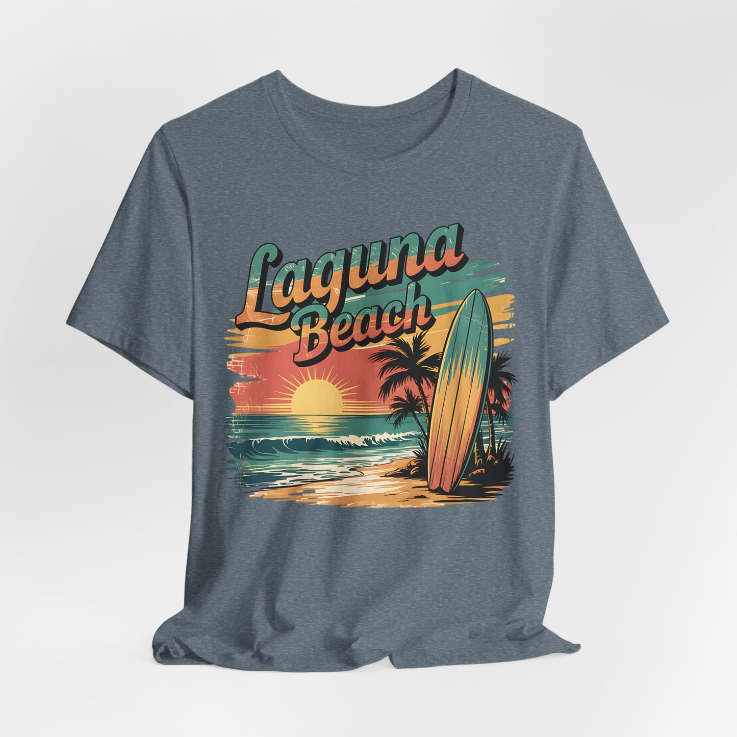 The Laguna Beach Surf Tee - Unisex Jersey Short Sleeve Shirt for Beach Lovers features a gray design with a retro sunset, ocean, palm trees, surfboard graphic, and bold Laguna Beach lettering—ideal for coastal style fans.