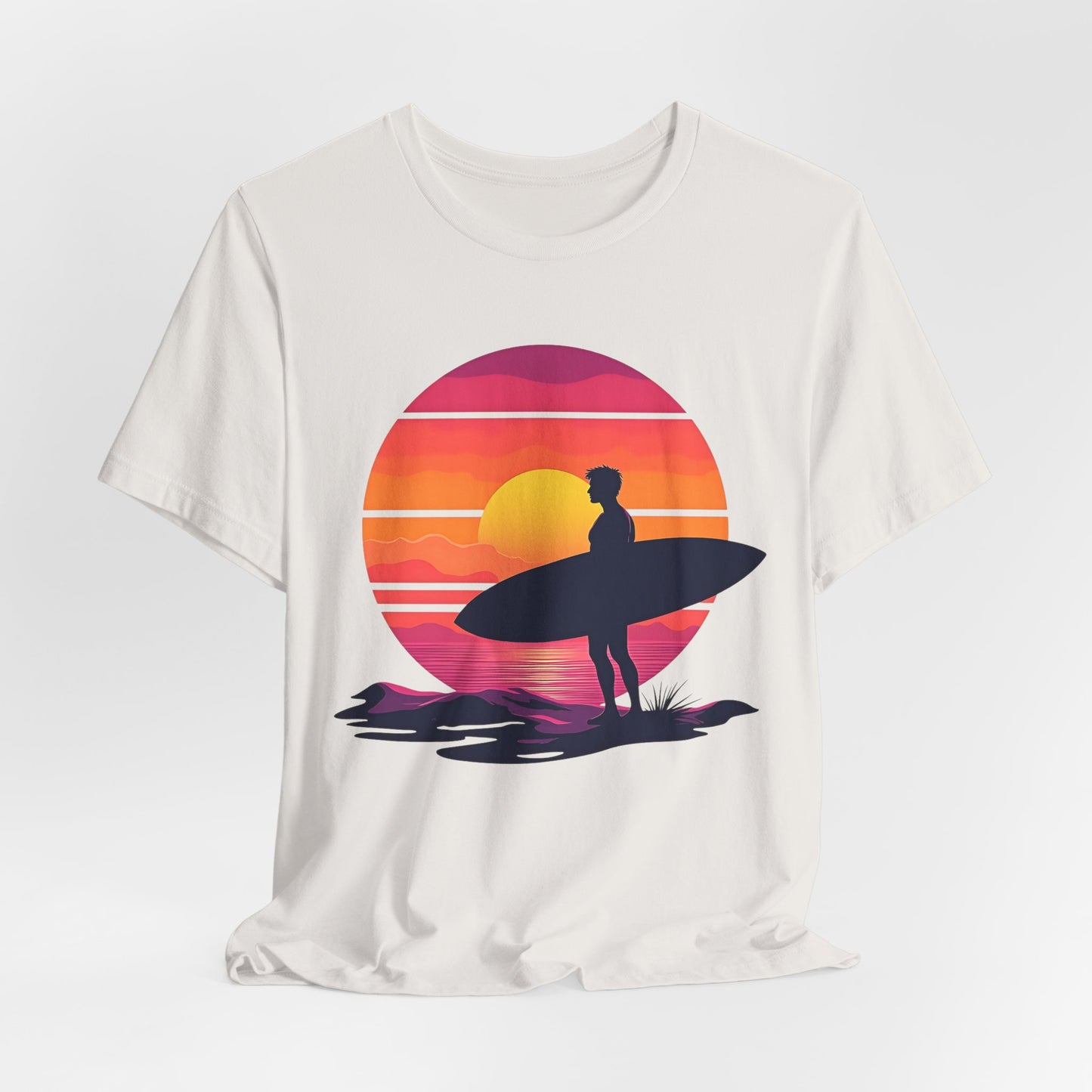 The Sunset Surfing Unisex Jersey T-Shirt features a surfer with a surfboard at sunset, brought to life with premium DTG printing. Perfect for beach lovers looking for comfort and style.