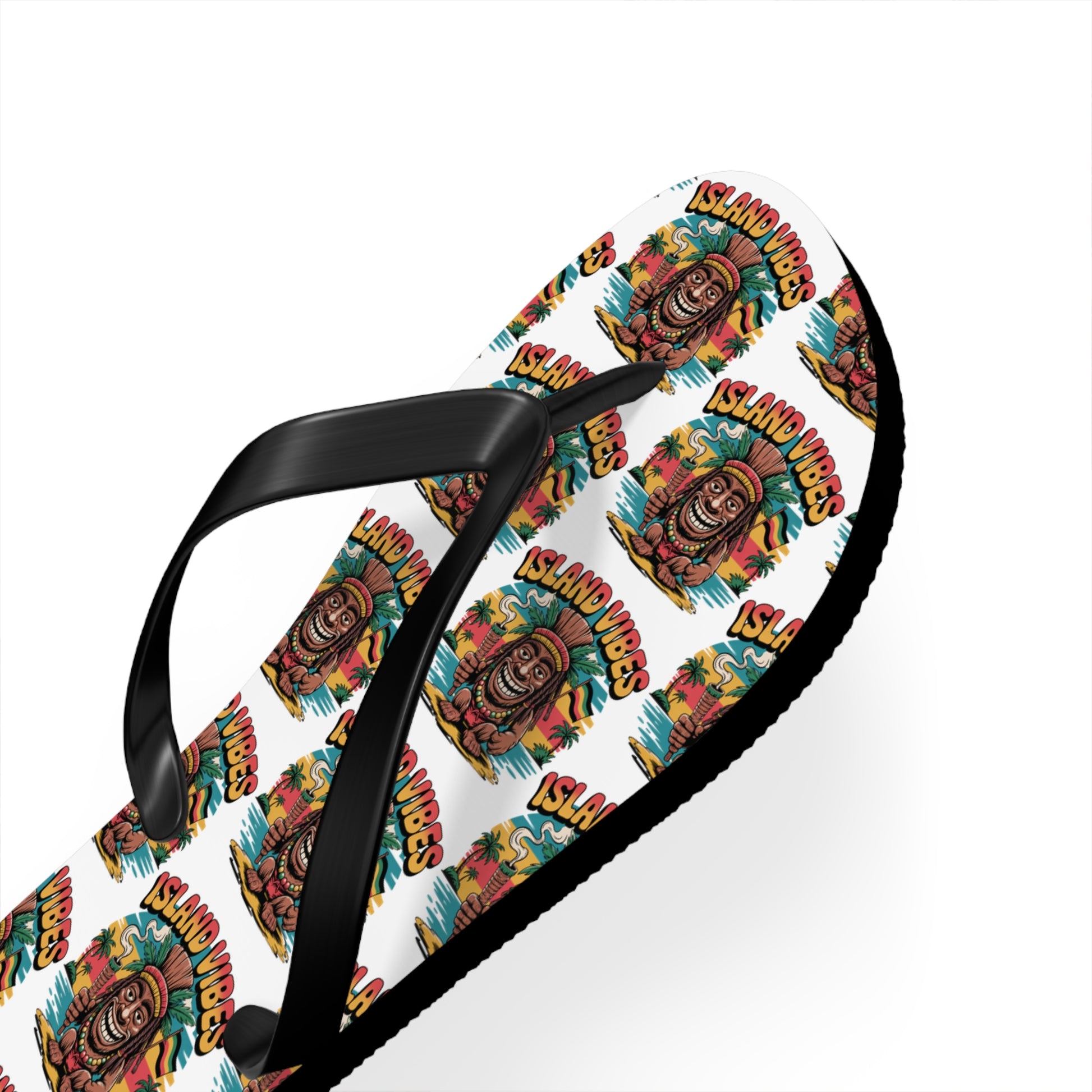 Island Vibes Tiki Flip Flops – Colorful Casual Footwear for Summer Fun. These flip flops feature a white base with a vibrant tiki mask, repeated “ISLAND VIBES” print, black straps, and a textured black sole—ideal for beach lovers.