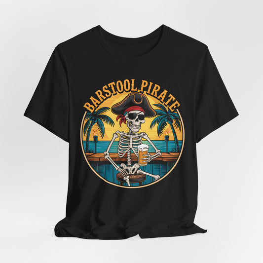 The Barstool Pirate Graphic T-Shirt features a skeleton pirate at a tropical bar with palm trees and a sunset. This fun unisex jersey short sleeve shirt is perfect for anyone who loves bold, playful styles.