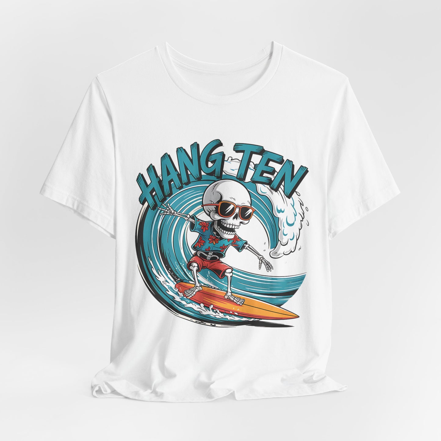The Surfing Skeleton T-Shirt - Hang Ten Unisex Jersey Tee features a cartoon skeleton in sunglasses and red shorts riding a big blue wave, with a bold Hang Ten design above—perfect for beach lovers.