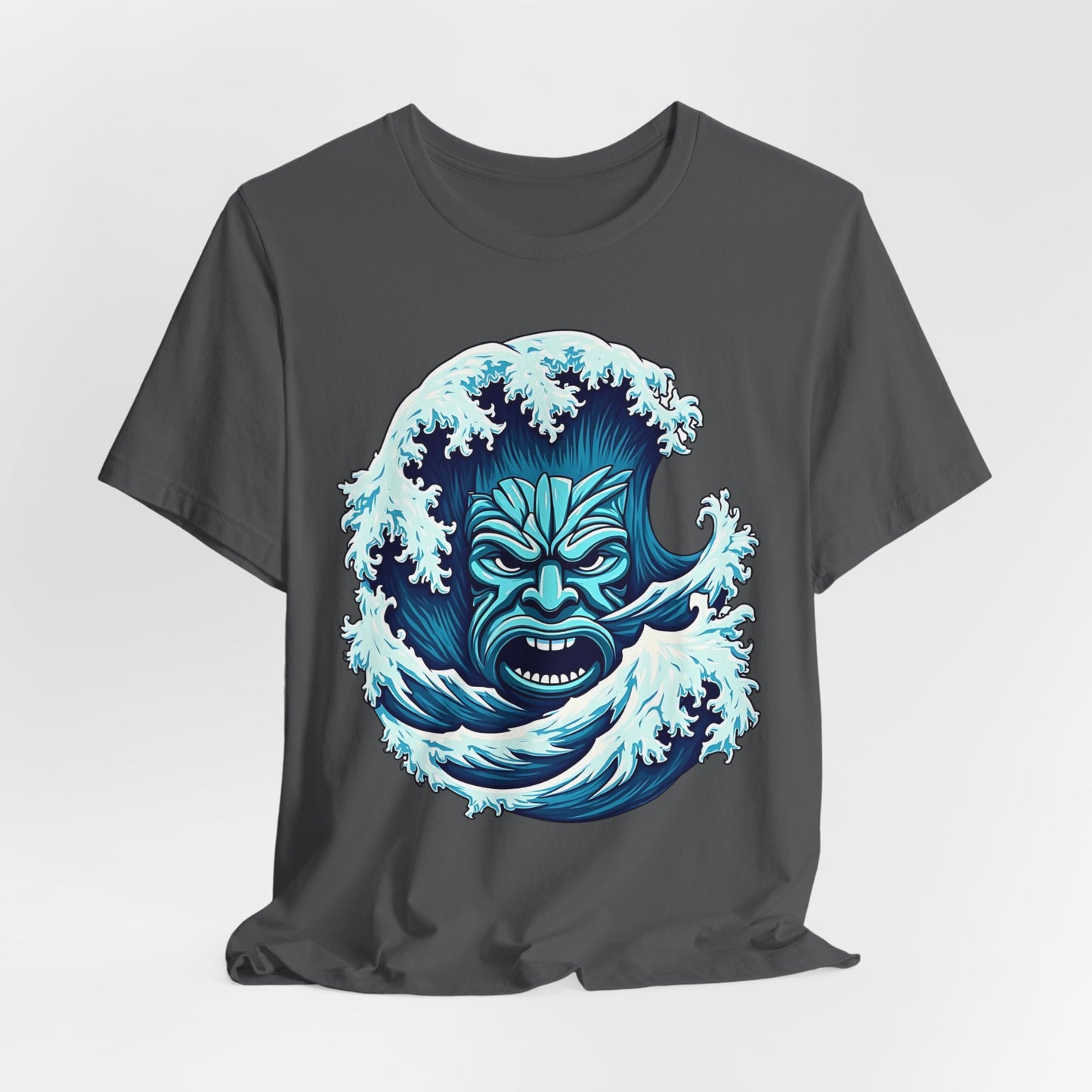 Introducing the Ocean Wave Tiki- Adventure Vibes: a dark gray unisex jersey tee with a bold blue tribal wave face and splashing water graphic. Made from soft Airlume cotton, it’s perfect for beach lovers seeking style and comfort all day.
