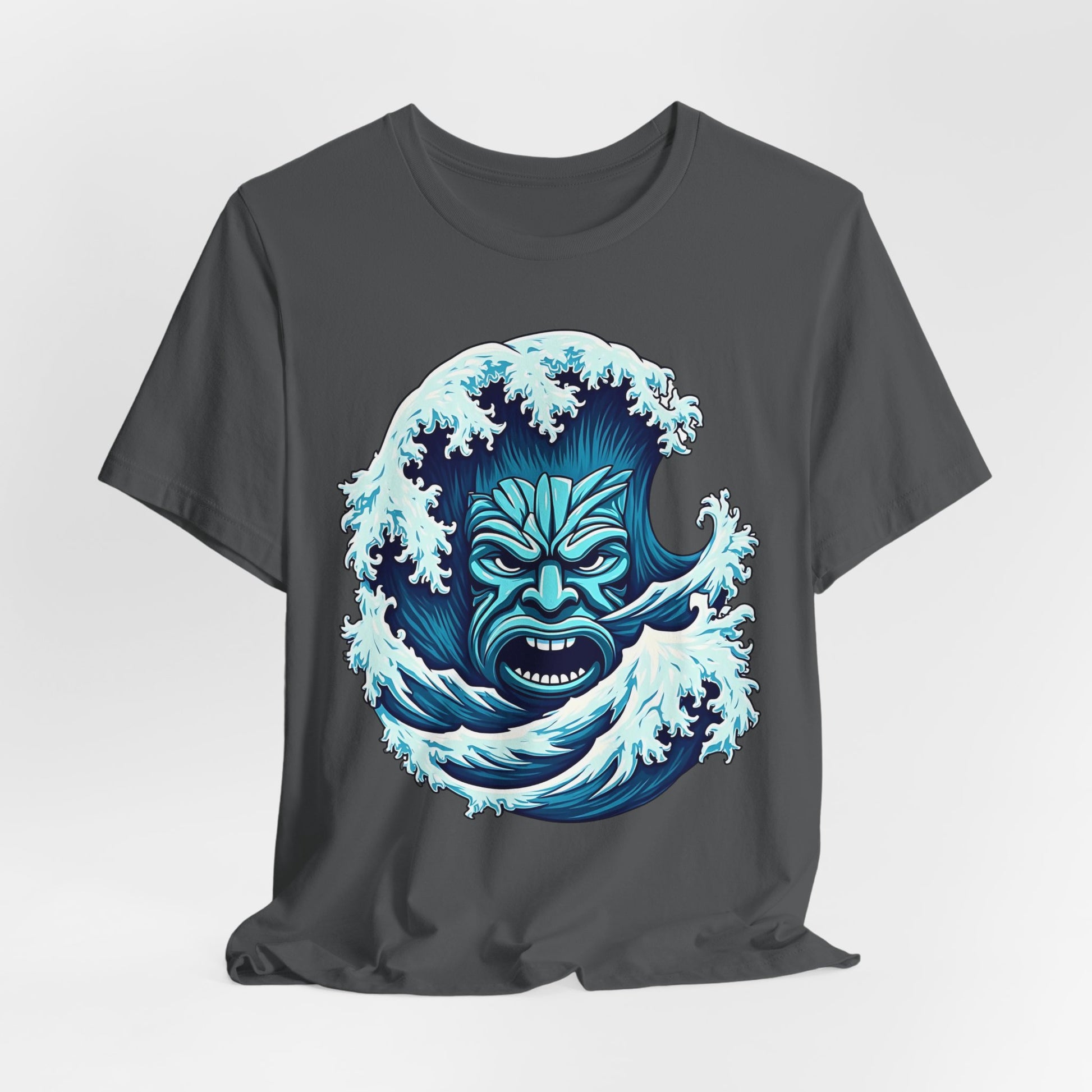 Introducing the Ocean Wave Tiki- Adventure Vibes: a dark gray unisex jersey tee with a bold blue tribal wave face and splashing water graphic. Made from soft Airlume cotton, it’s perfect for beach lovers seeking style and comfort all day.