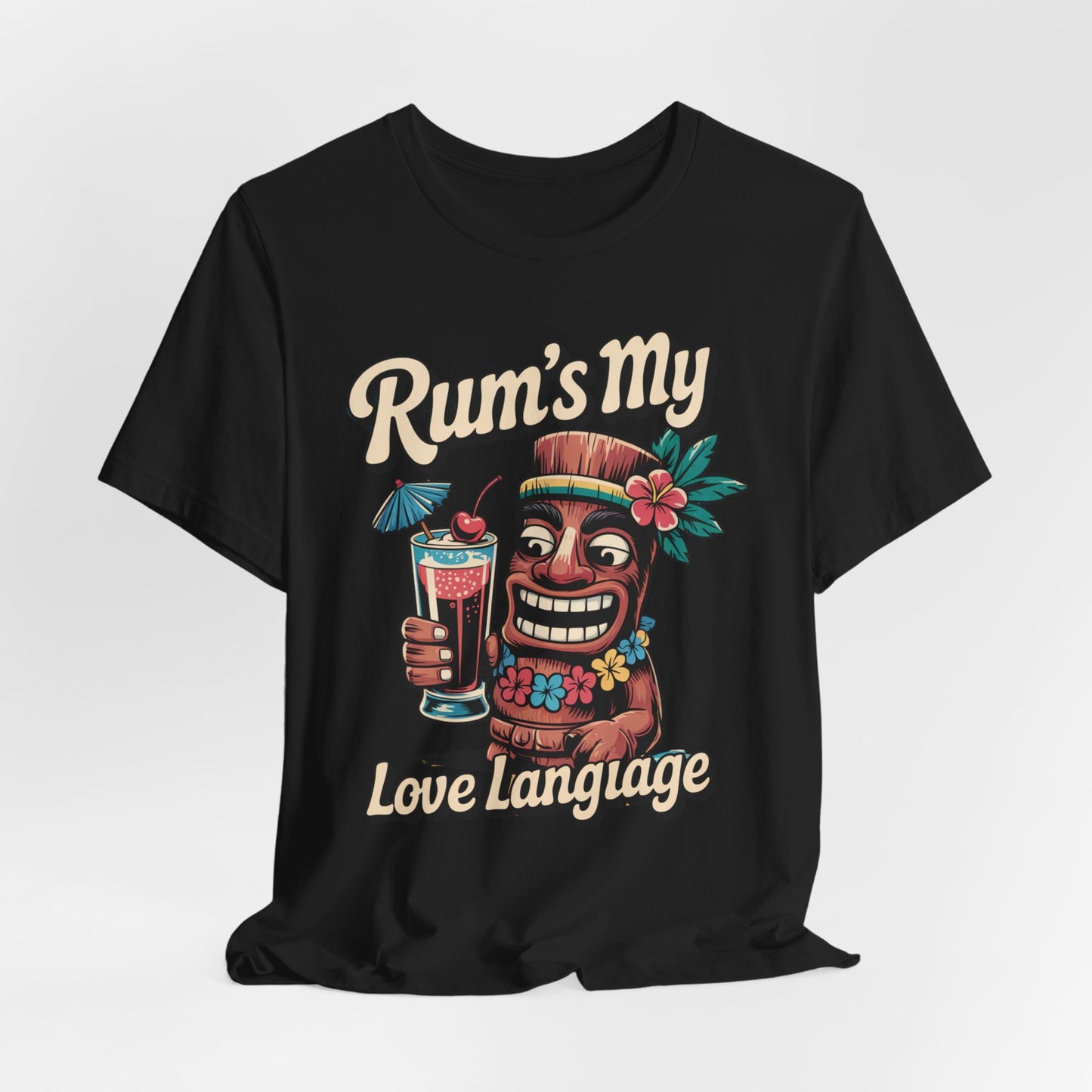 The Tropical Rum Themed Tiki T-Shirt features a lively tiki character with drink, flowers, and umbrella, plus retro Rums My Love Language text—perfect for adding tropical flair to any occasion. Unisex Jersey Short Sleeve style.