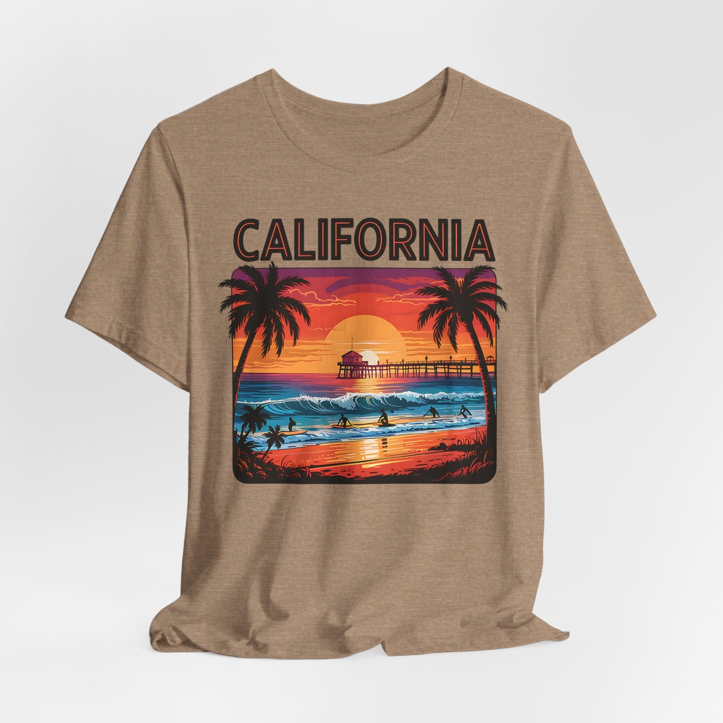 The California Sunset Unisex Jersey T-Shirt - Vintage Beach Vibe features a colorful ocean sunset with palm trees, surfers, and a pier. CALIFORNIA is boldly displayed above the scene—perfect for beach lovers and effortless casual style.