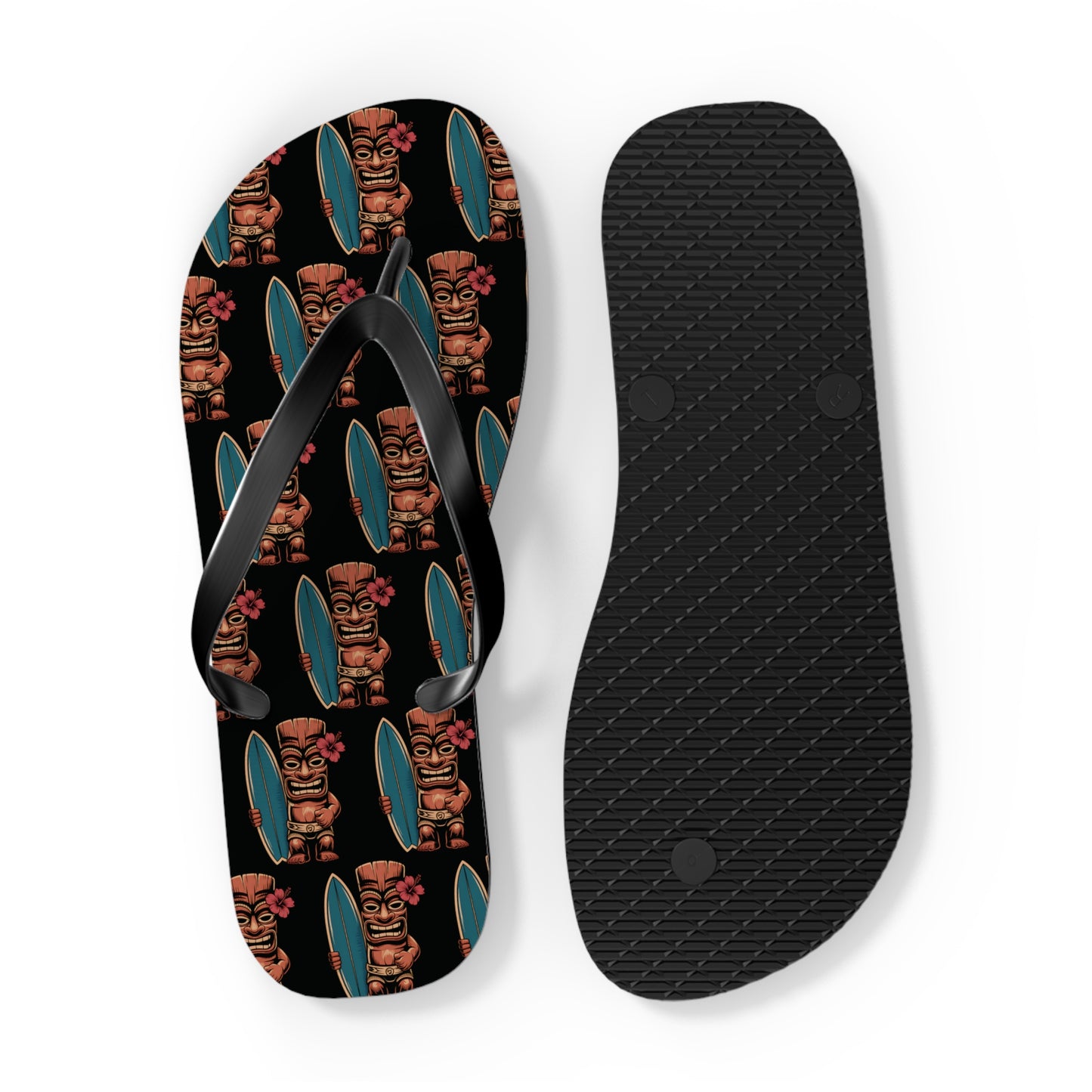 The Tiki Surf Flip Flops - Fun Summer Beach Sandals feature one sandal with colorful tiki statues holding surfboards on a black background, and the other with a plain black textured sole.