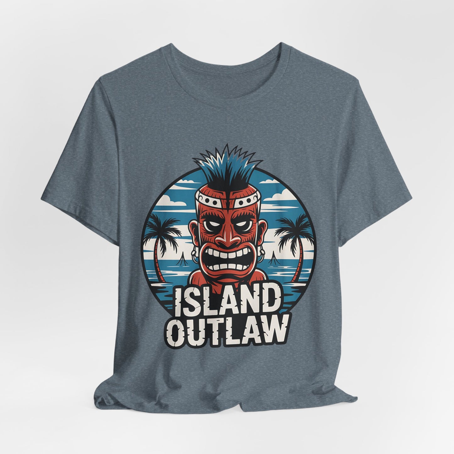 The Island Outlaw Tiki T-Shirt - Unisex Jersey Tee for Tropical Vibes features a fierce gray tiki mask with blue hair, palm trees, and an ocean scene, plus “ISLAND OUTLAW” below—ideal for vacations or the beach.