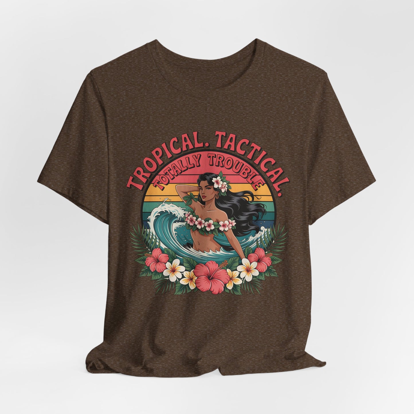 The Tropical Tactical Unisex Jersey T-Shirt - Aloha Vibes & Summer Fun features a brown tee with a hula dancer, floral leis, palm leaves, Tropical Tactical above, Totally Trouble! below, and colorful flowers at the bottom.