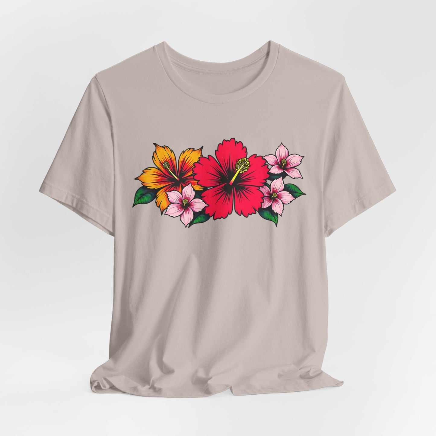 The Tropical Floral Unisex Jersey T-Shirt is a light beige top with vibrant floral designs—large red and yellow hibiscus, three small pink flowers, and green leaves. Perfect for summer, beach days, or casual gatherings.