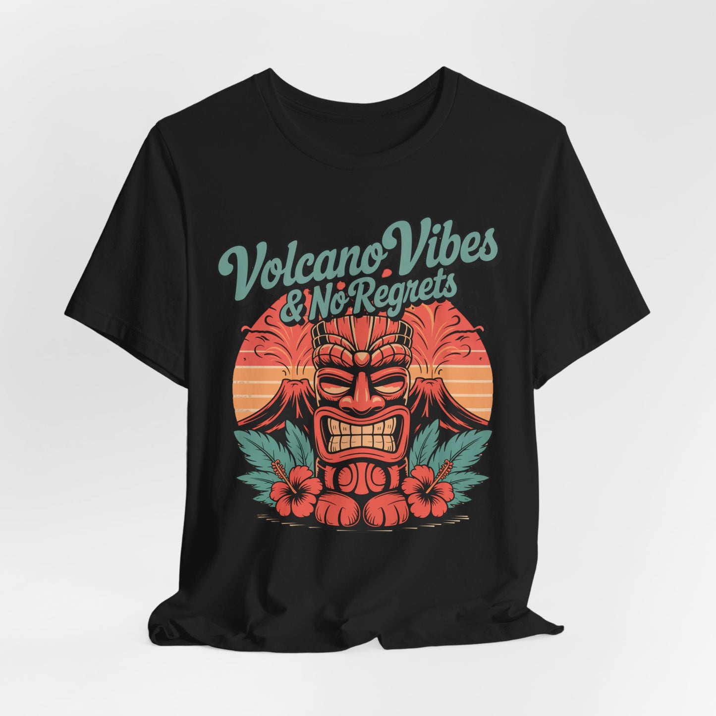 The Volcano Vibes and No Regrets Unisex Tiki T-Shirt features a red tiki mask, tropical leaves, hibiscus flowers, and sunset with bold “Volcano Vibes & No Regrets” text—a retro graphic short sleeve tee perfect for summer adventures.