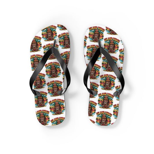 Island Vibes Tiki Flip Flops – Colorful Casual Footwear for Summer Fun feature black straps, a vibrant tropical design with tiki masks, palm trees, and repeating “ISLAND VIBES” text—perfect for vacations or beach lovers.