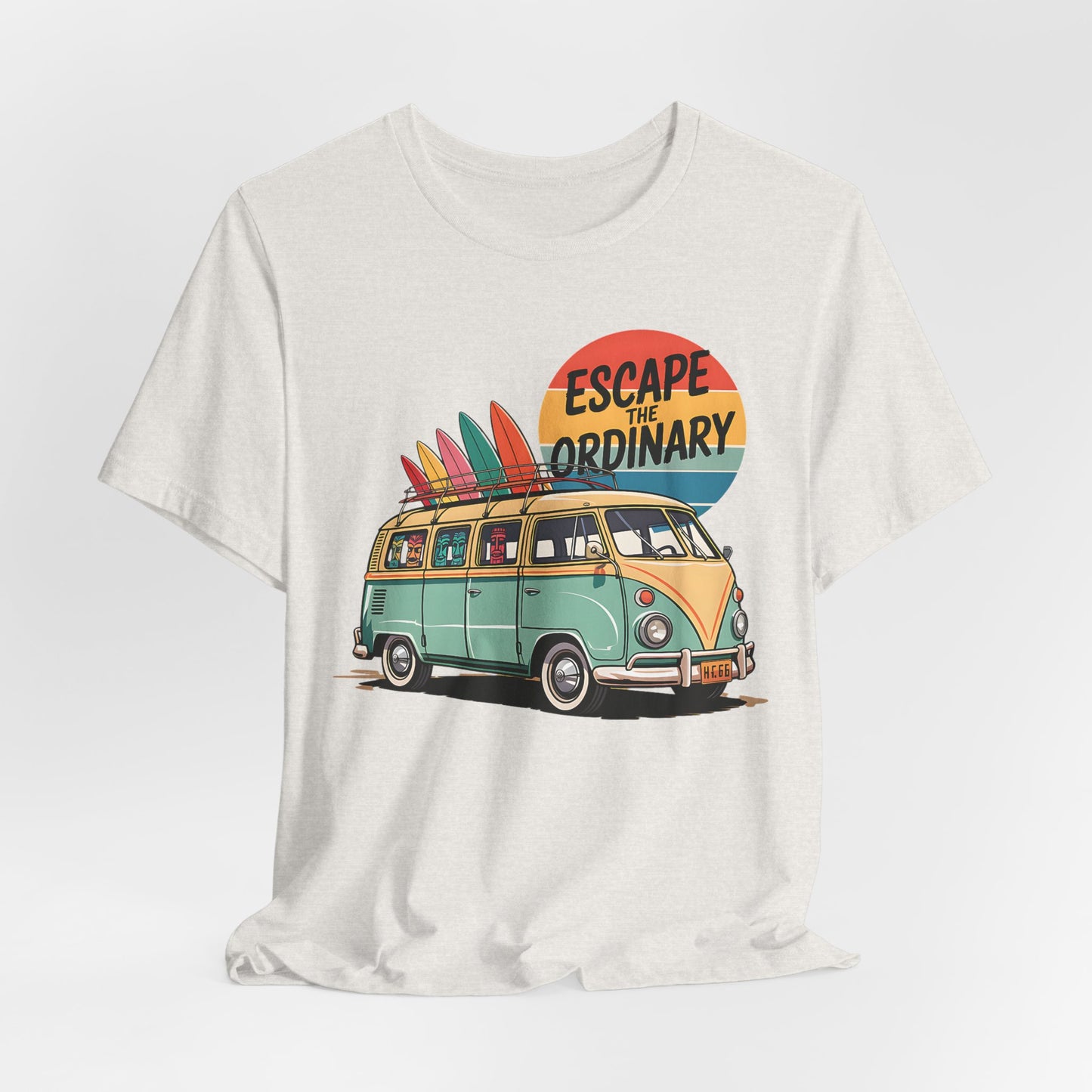 The Escape the Ordinary Surf Tee is a unisex jersey short sleeve shirt featuring a retro van with surfboards at sunset and the phrase Escape the Ordinary—perfect for summer festivals and relaxed, casual vibes.
