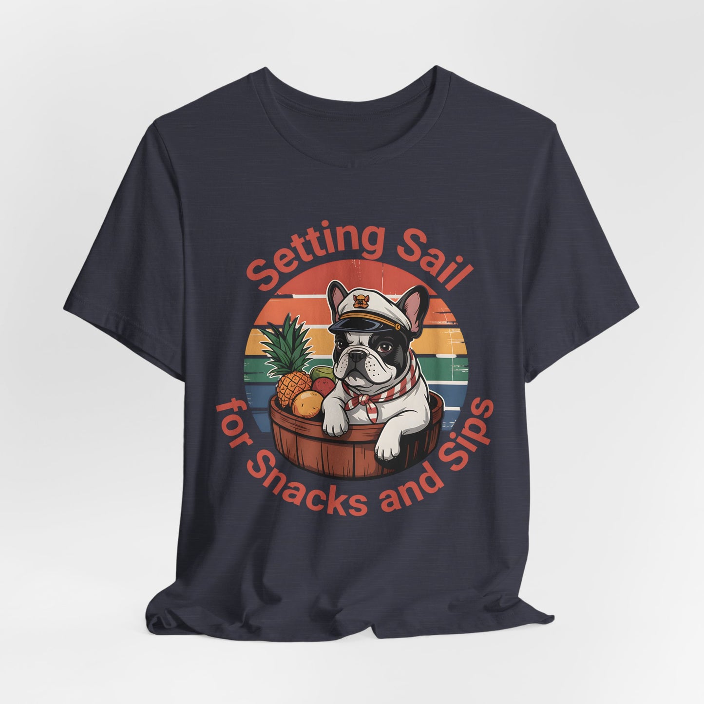 Great for dog lovers and beach fans, the Setting Sail for Snacks and Sips T-Shirt features a French bulldog captain in a barrel with pineapple and drink. The text reads: Setting Sail for Snacks and Sips. Fun unisex jersey tee!.