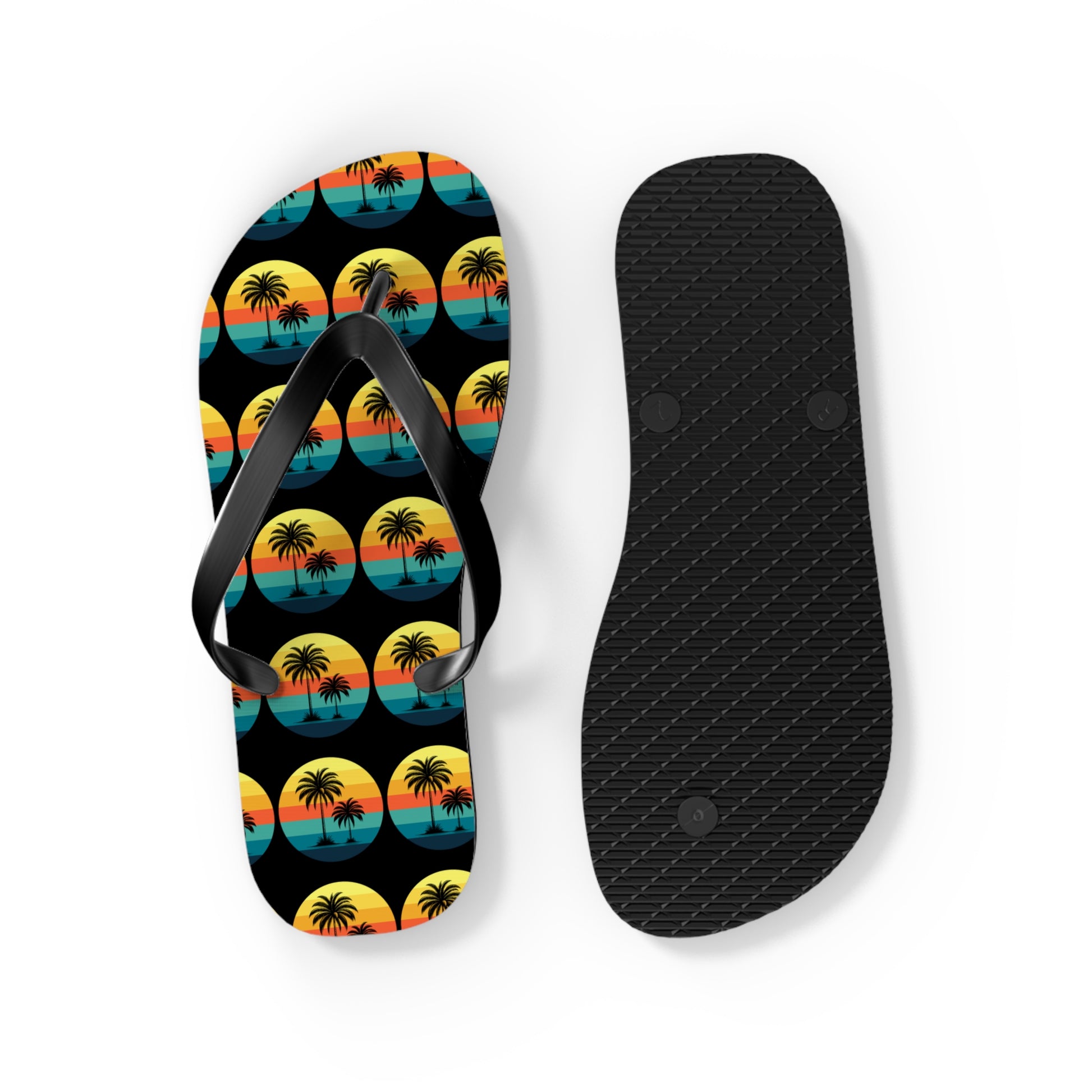 Tropical Sunset Flip Flops - Summer Vibes with Palm Trees: One flip flop displays the textured black sole and the other shows a sunset scene with palm trees in black, yellow, orange, and blue—perfect for beach lovers summer wardrobes.