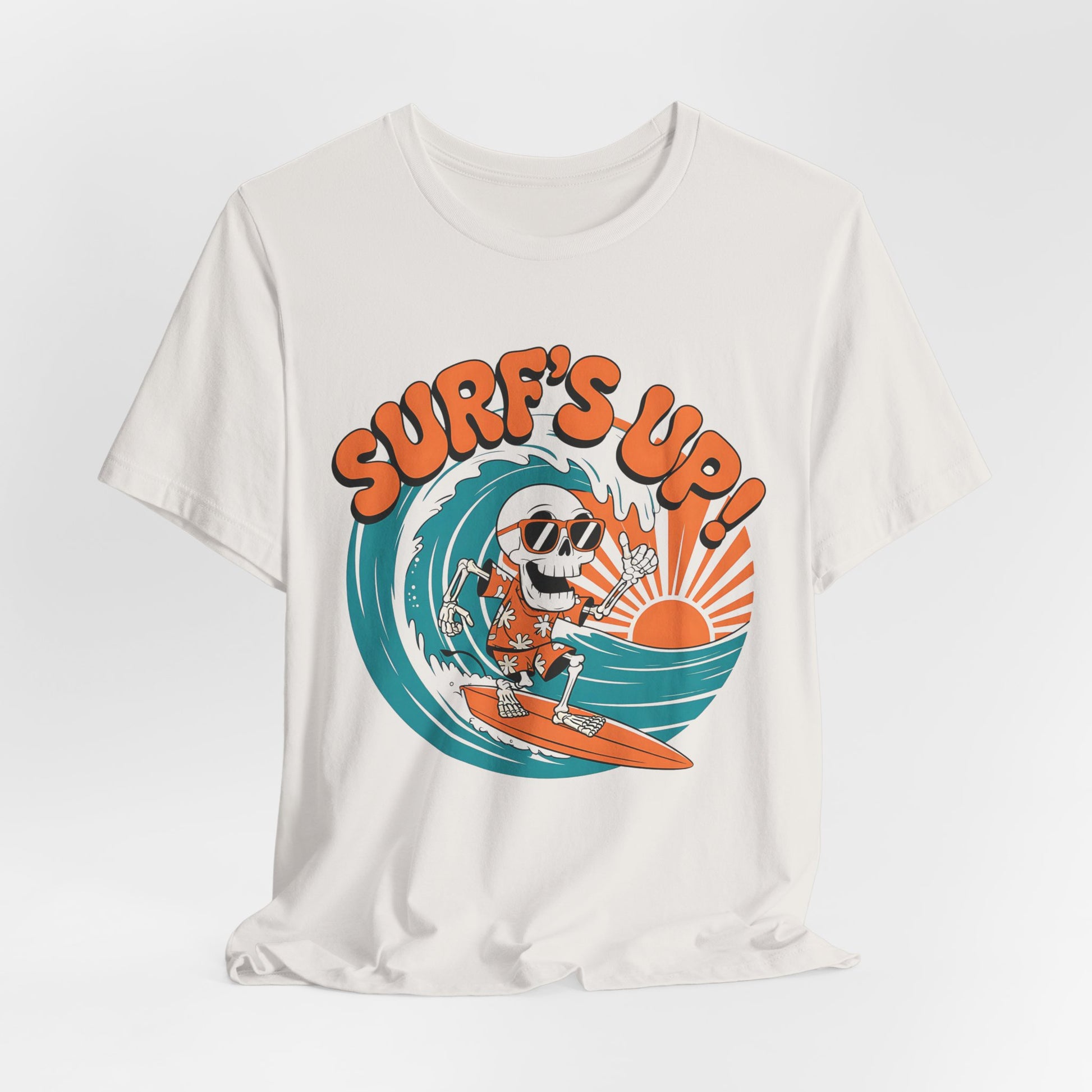 The Surfs Up Skeleton Unisex Jersey Tee features a skeleton in sunglasses surfing with an orange sun and bold SURFS UP!—a fun beach vibe t-shirt perfect for summer outings.