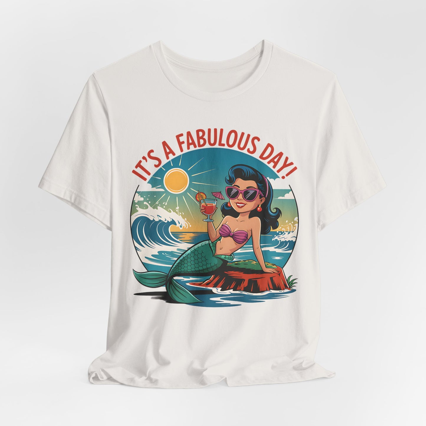 The Fabulous Day Mermaid Unisex Tee features a cartoon mermaid in sunglasses and a bikini top lounging on a rock, drink in hand, with sun, waves, and ITS A FABULOUS DAY! text—ideal for comfort at any fantasy-themed event.