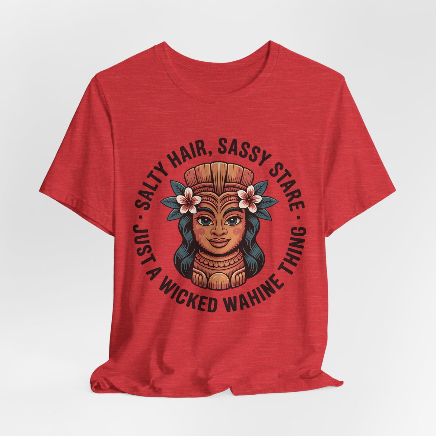 The Wicked Wahine Graphic T-Shirt - Salty Hair, Sassy Stare T-Shirt is a red unisex tee featuring an illustrated wahine with a Polynesian headdress and flowers, plus the text: Salty Hair, Sassy Stare, Just a Wicked Wahine Thing. Perfect for beach trips.