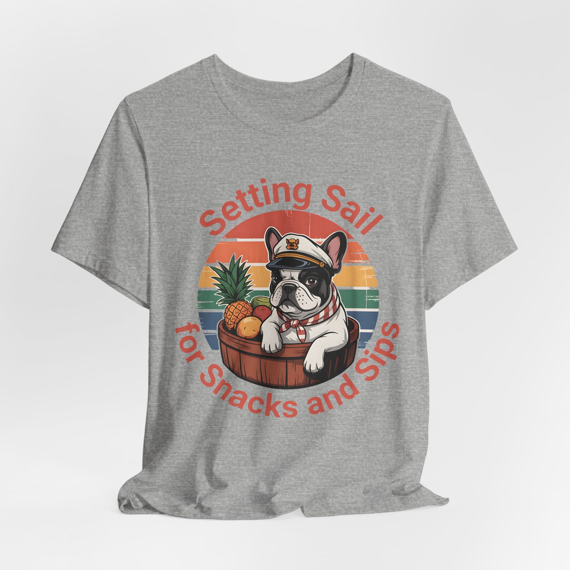 Perfect for dog and beach fans, the Setting Sail for Snacks and Sips T-Shirt features a French bulldog in a captain’s hat relaxing in a barrel with a pineapple at sunset. Fun unisex jersey tee reads: Setting Sail for Snacks and Sips.