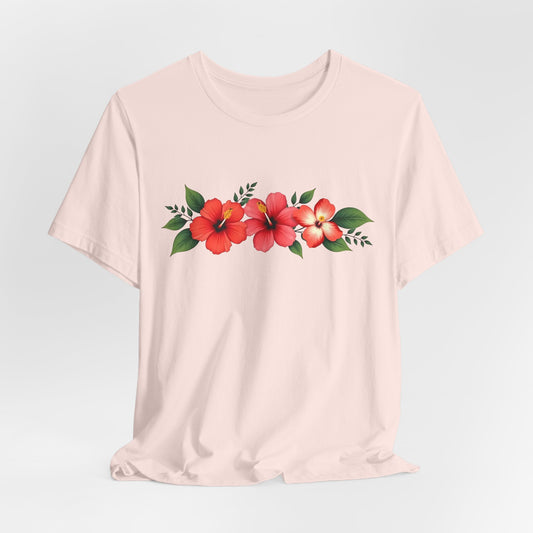 The Floral Unisex Short Sleeve T-Shirt—Perfect for Spring and Summer—is a light beige tee made from 100% Airlume cotton, with vibrant red and orange hibiscus flowers and green leaves printed across the chest. Ideal for casual outings.