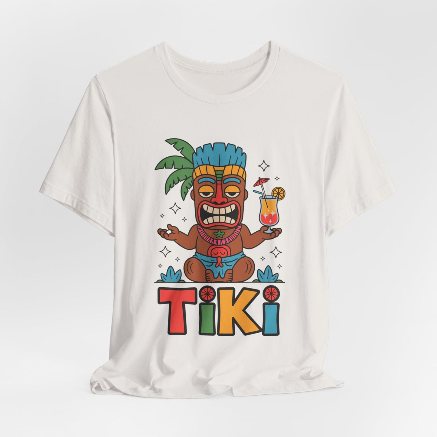 The Tiki Party Unisex Jersey Tiki T-Shirt features a colorful cartoon tiki with a blue headdress and drink, TIKI lettering, and eco-conscious production—perfect for summer parties and tropical vibes.