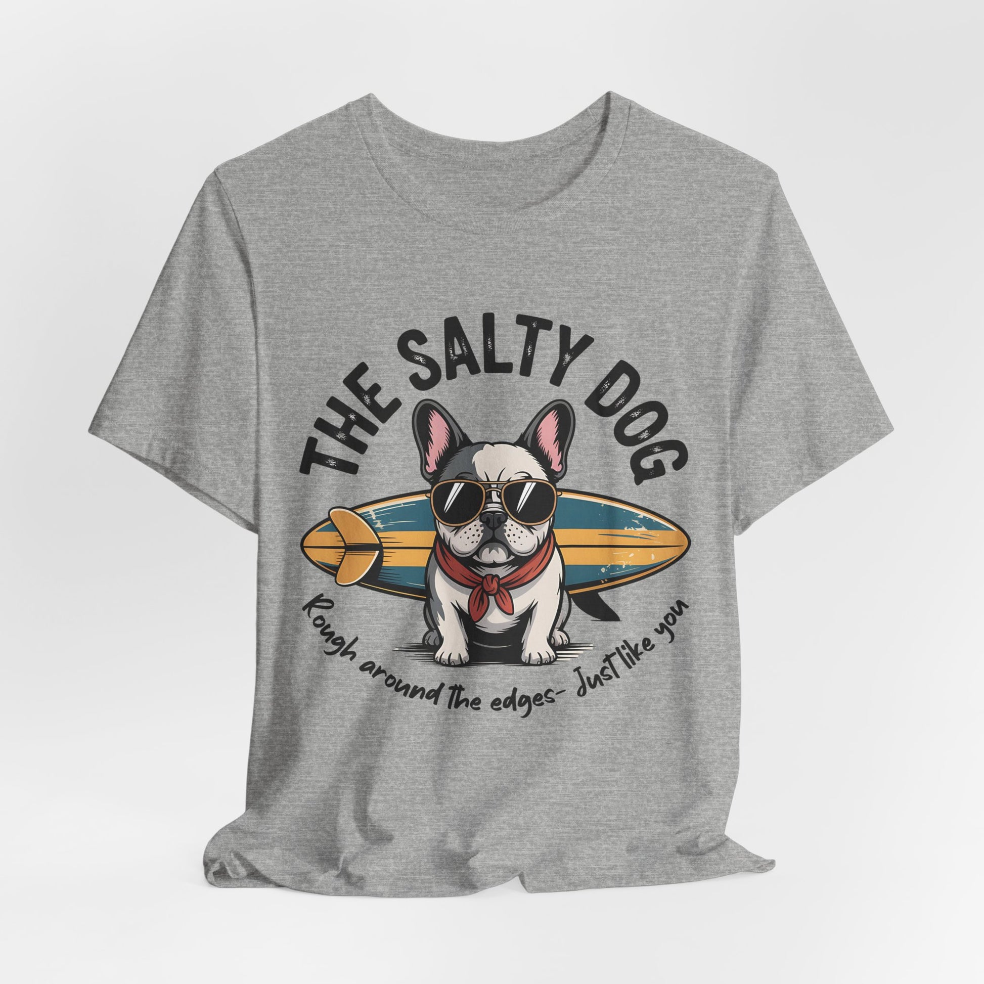 The Salty Dog Unisex Surf T-Shirt: gray tee with a French Bulldog in sunglasses and red scarf, posing with a surfboard and THE SALTY DOG text. Great for beach days—rugged style for anyone who loves the coast.