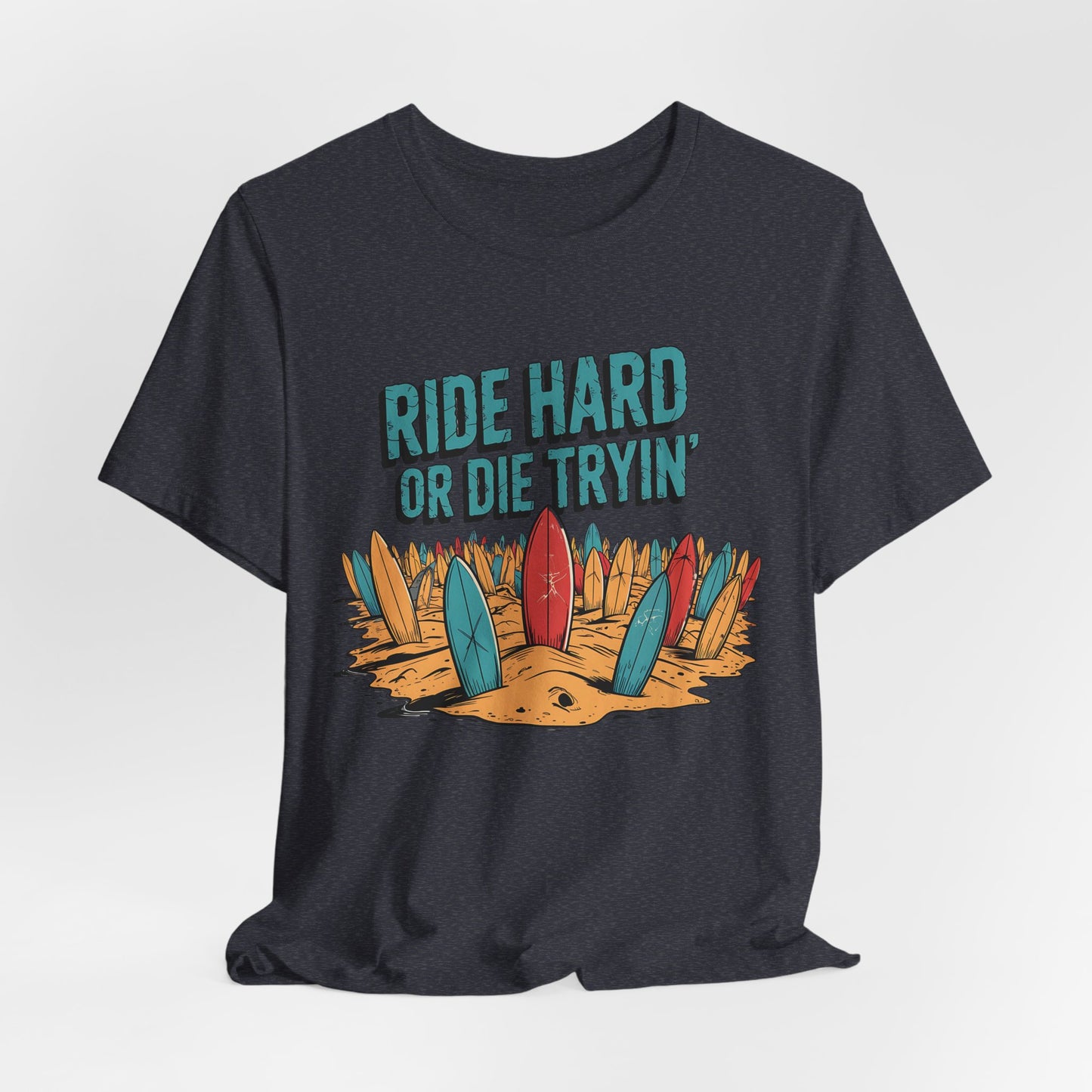 The Surfing T-Shirt - Ride Hard or Die Tryin Unisex Jersey features vibrant surfboards in the sand, bold text, and a dark hue—ideal for beach lovers and adventure seekers living the surf lifestyle.