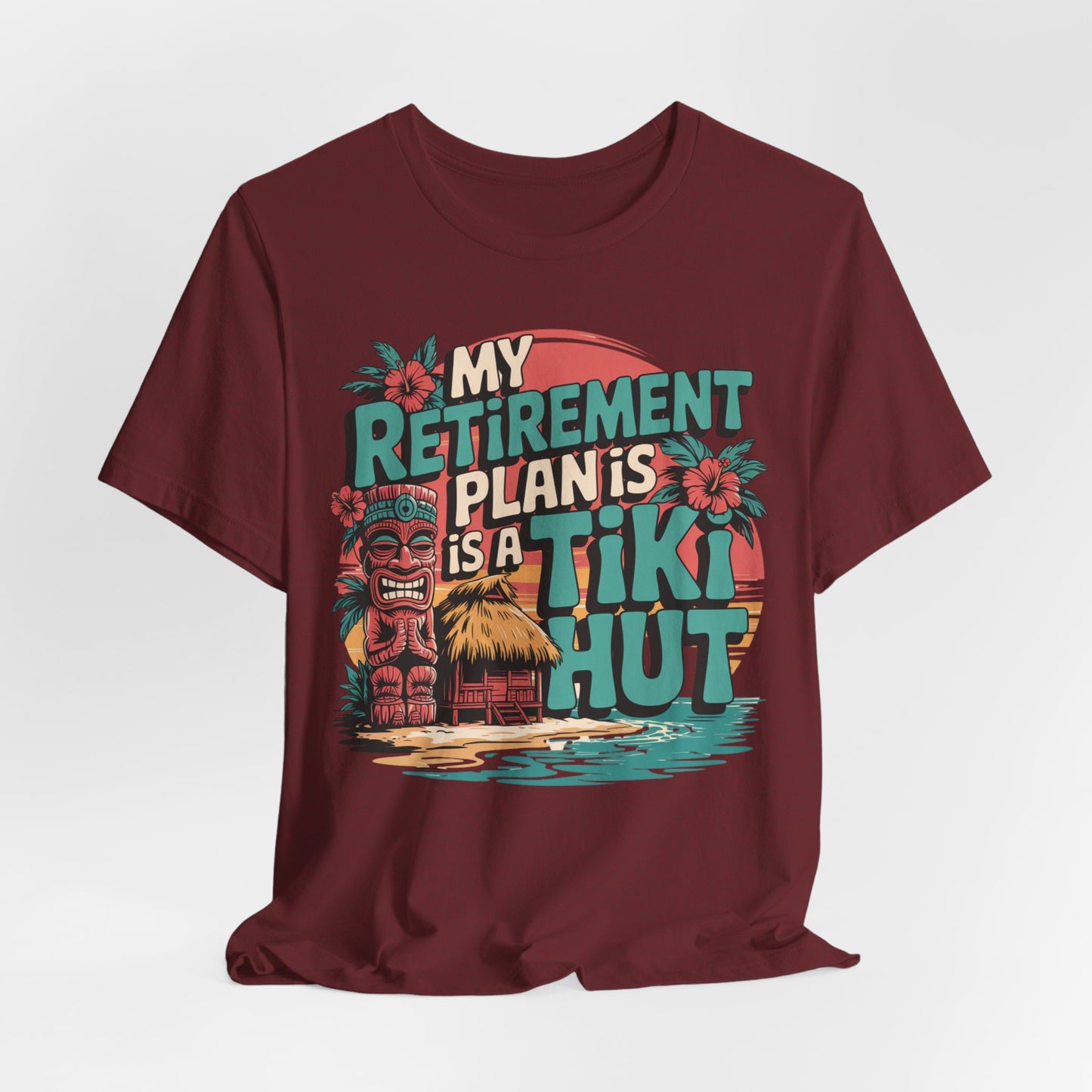 The Tiki Hut Retirement Plan Tiki T-Shirt is a maroon unisex tee with a vibrant tiki hut, palm trees, and sunset graphic—ideal for beach lovers or as a retirement gift. Features bold “My Retirement Plan is a Tiki Hut” text.