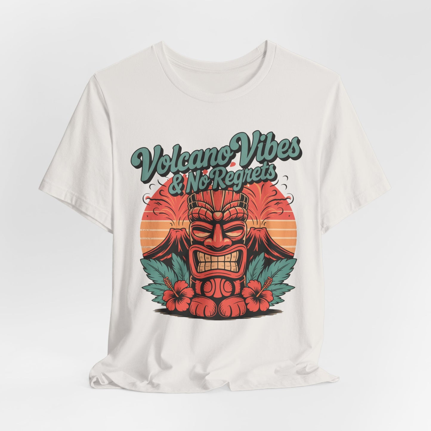 The Volcano Vibes and No Regrets Unisex Tiki T-Shirt is a graphic short sleeve tee with a vibrant tiki statue, volcano, sun rays, and hibiscus—perfect for channeling summer vibes on all your adventures.