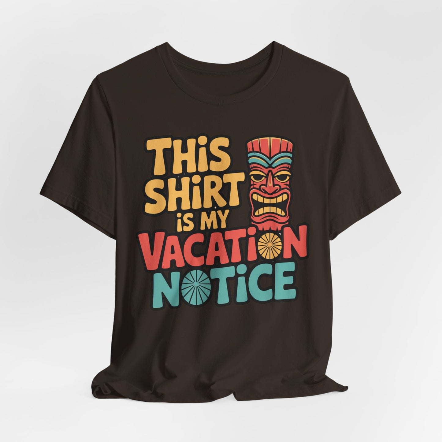 The Tiki T-Shirt - This Shirt is My Vacation Notice Funny Travel T-Shirt features colorful text and a tiki mask on a black unisex jersey, offering a playful, vacation-themed design.
