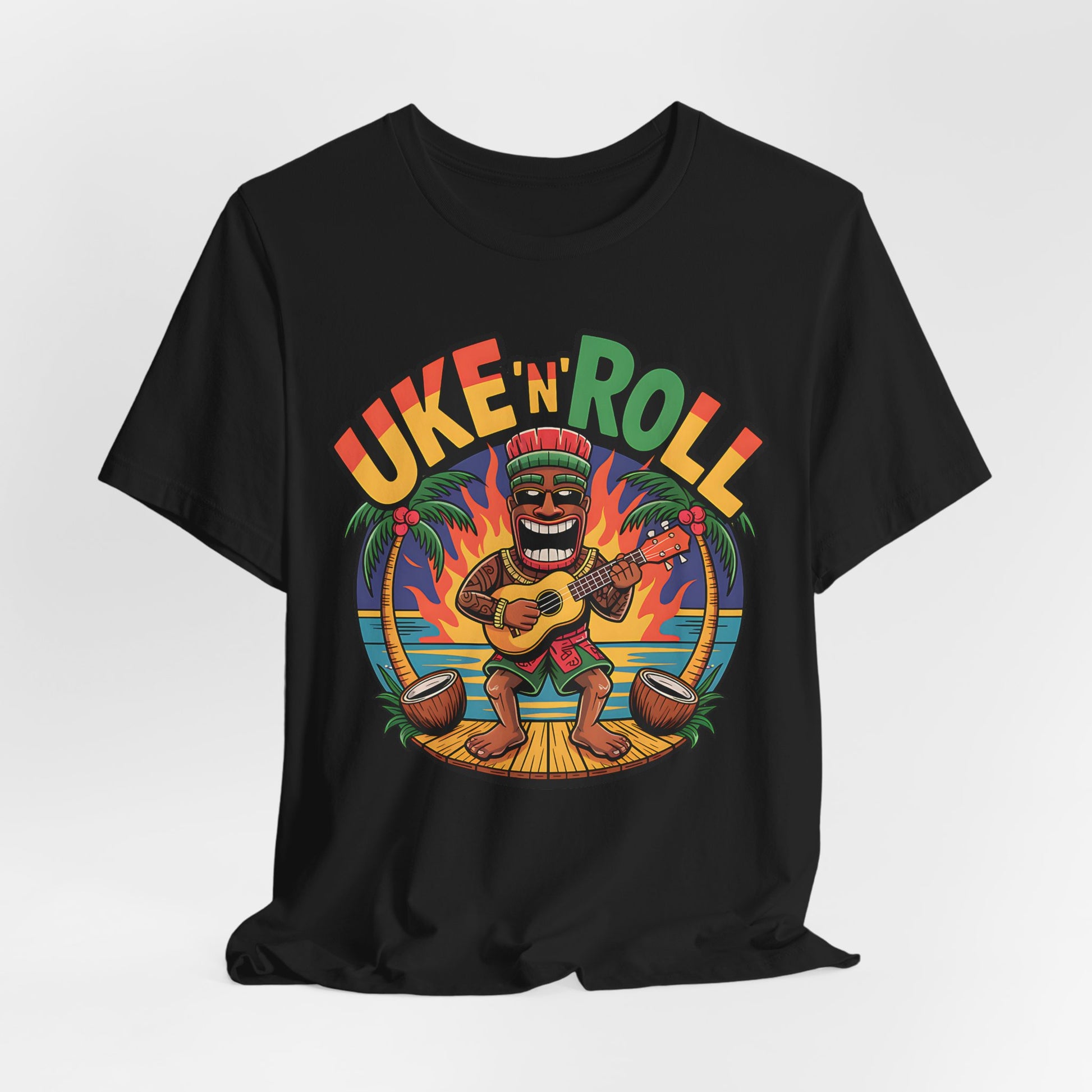 Perfect for music and beach lovers, the Uke n Roll Unisex Jersey Tiki T-Shirt features a cartoon playing ukulele on a sunset beach under bold Uke ‘n’ Roll text.
