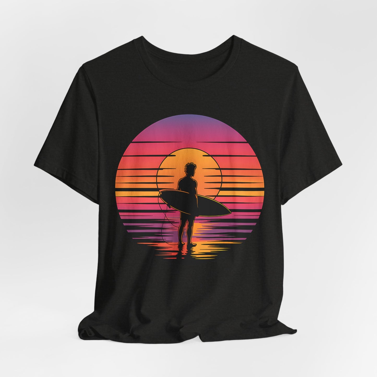 The Retro Surfing Unisex Jersey T-Shirt - Sunset Vibes features a silhouetted surfer with a board against a vibrant sunset, made from soft Airlume combed and ring-spun cotton for all-day comfort and beachy style.