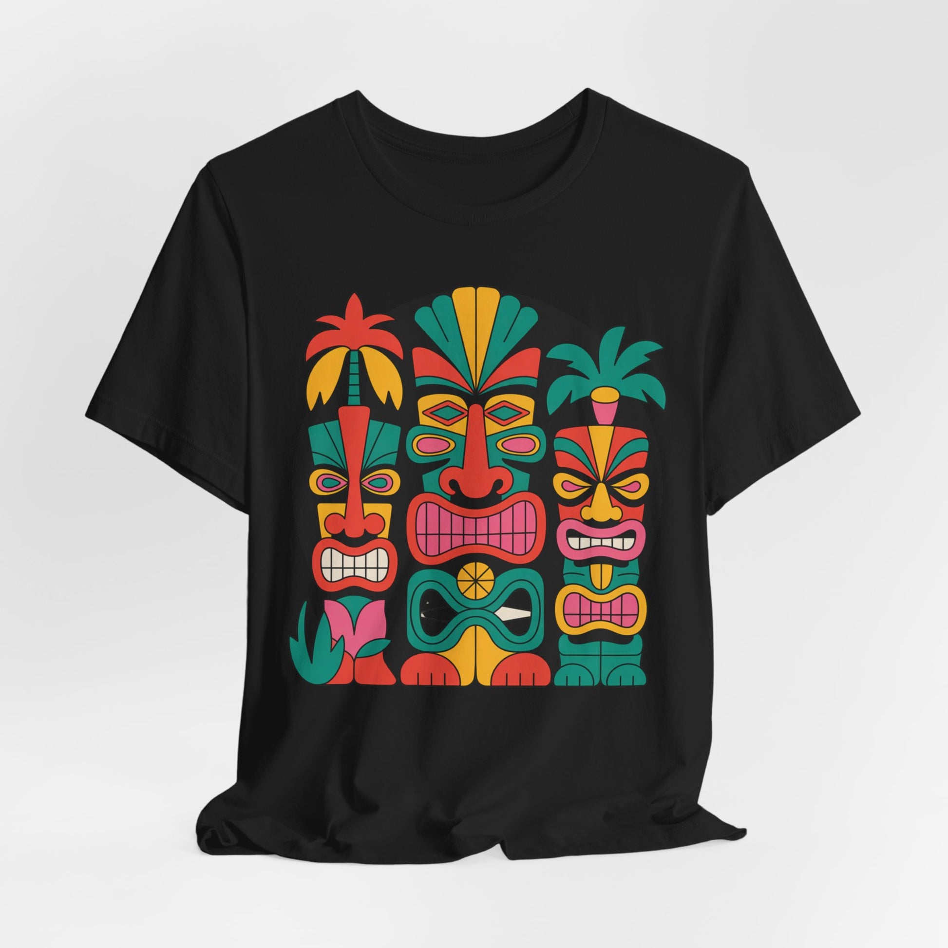 The Tiki Vibes Unisex Tiki T-Shirt is a black short sleeve tee for beach lovers, featuring four bold stylized tiki faces with colorful patterns, lush leaves, and palm details arranged around the vibrant graphic.