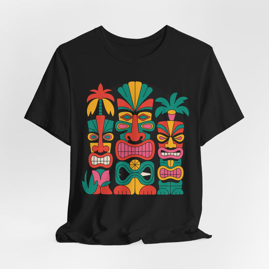 The Tiki Vibes Unisex Tiki T-Shirt is a black short sleeve tee for beach lovers, featuring four bold stylized tiki faces with colorful patterns, lush leaves, and palm details arranged around the vibrant graphic.
