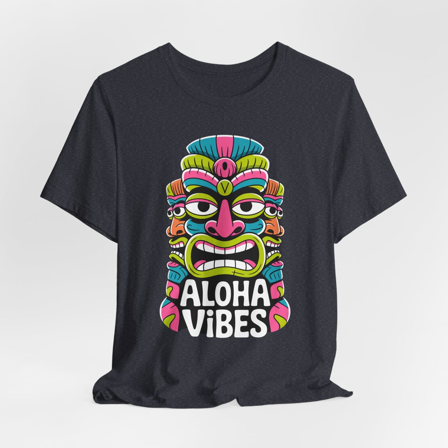 The Aloha Vibes Unisex Tiki T-Shirt – Fun Summer Graphic T-Shirt features a vibrant Tiki mask above the words ALOHA VIBES, combining adventure and relaxation in a stylish, comfortable design.