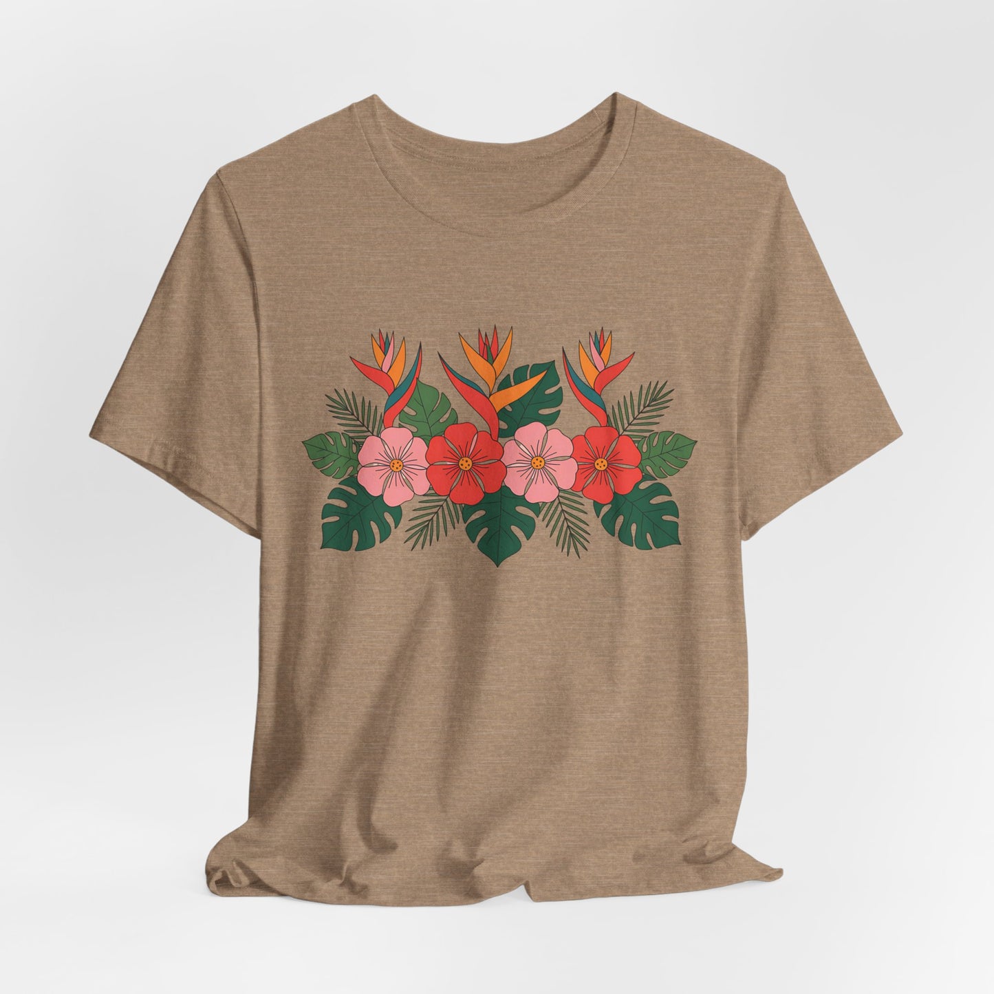 The Tropical Floral Unisex T-Shirt – Perfect for Summer Celebrations features a light brown color with red, pink, and orange floral prints, green leaves, tropical details, and is made from breathable fabric for all-day comfort.